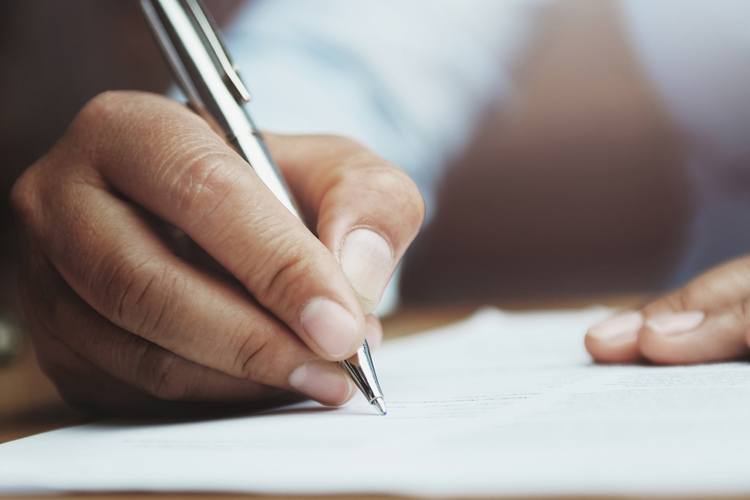 Hand writing a list of benefits